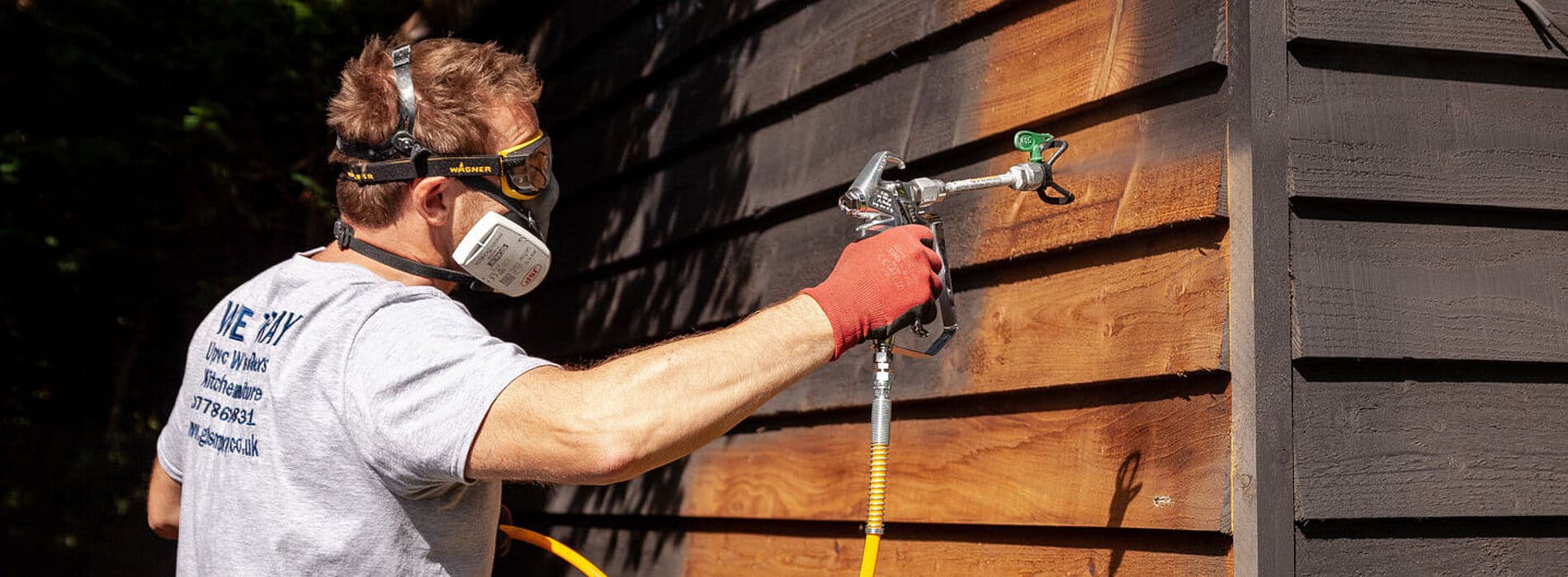 Man spraying paint with professional equipment